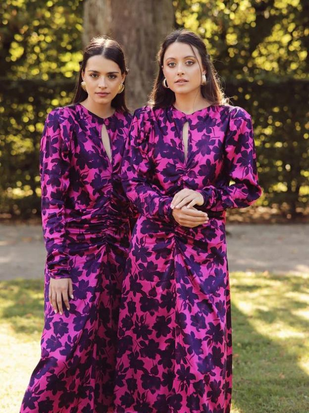 Two women wearing Larsuu dresses