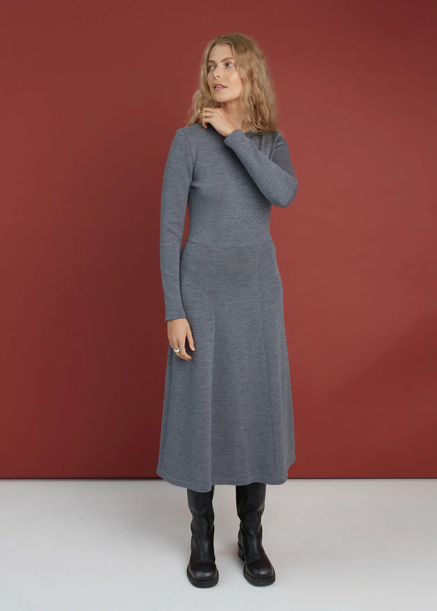 Woman wearing a-line merino dress in grey