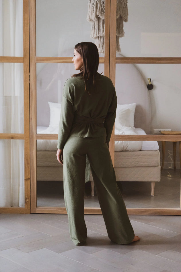 women facing the back with a green jumpsuit