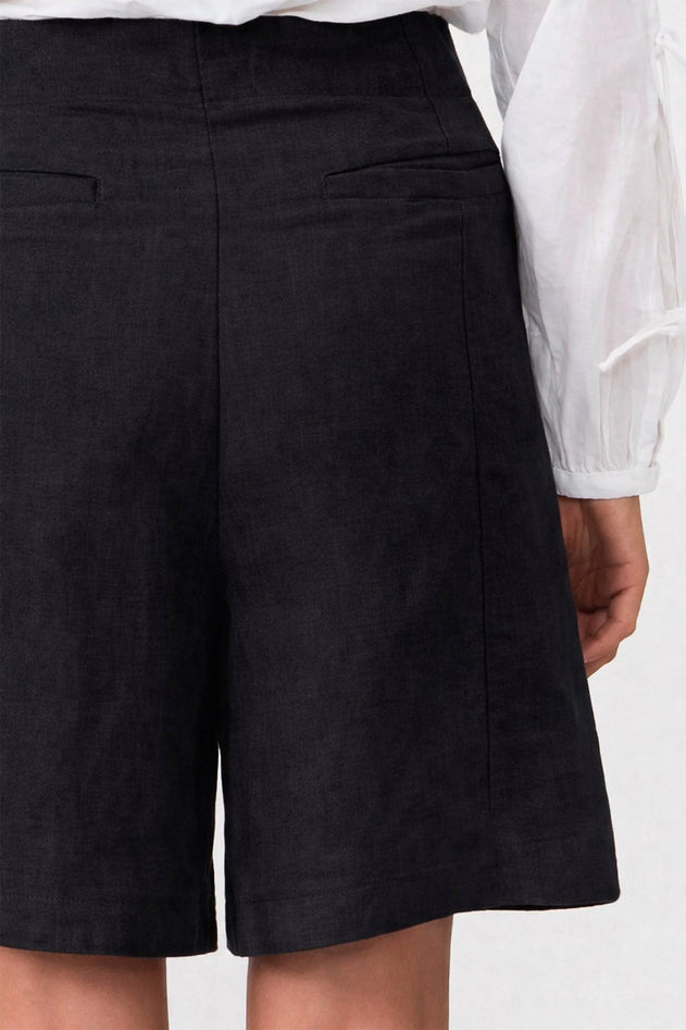 Black shorts worn by a person on a white background