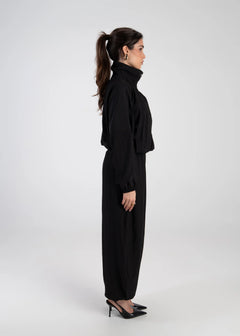 Woman wearing a black outfit on a white background