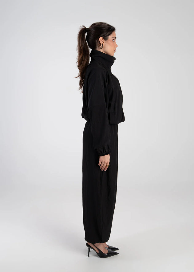 Woman wearing a black outfit on a white background