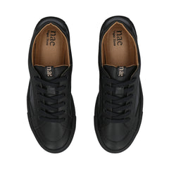 Black sneakers with brown insole on a white background