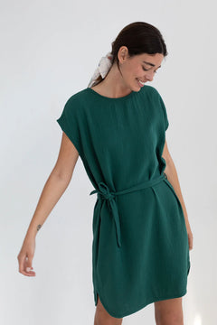 Woman wearing a green dress against a white background