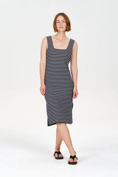 Woman wearing a black and white striped dress on a white background