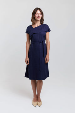 Woman wearing a navy blue dress on a white background