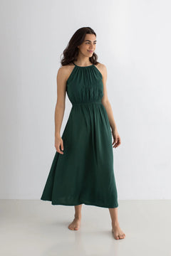 Woman wearing a green dress against a white background