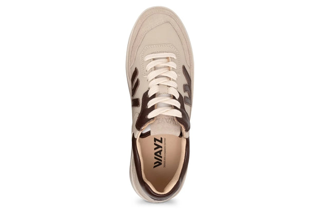 Beige sneaker with brown accents on a white background