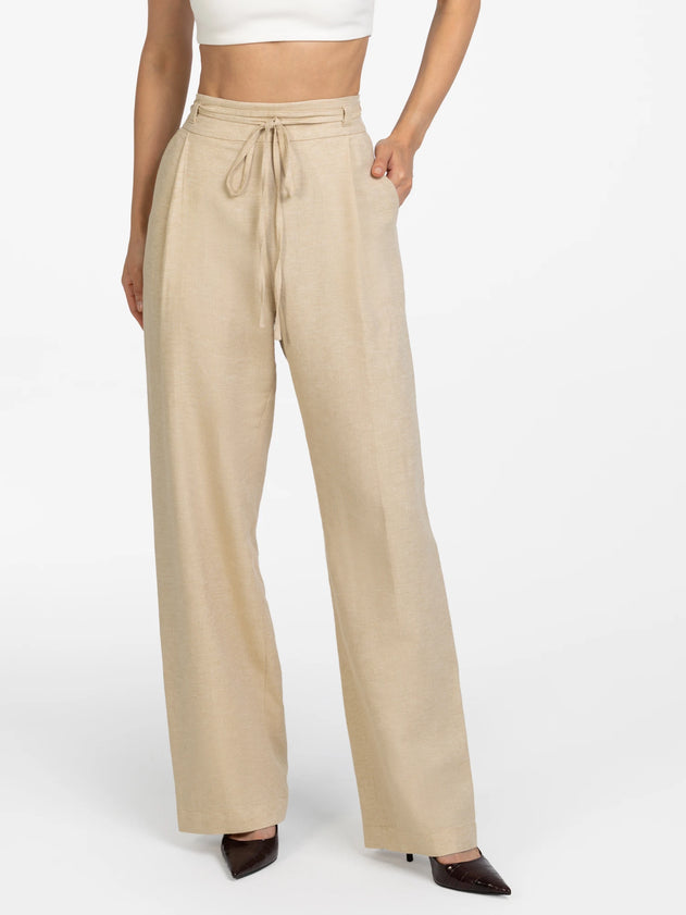 Beige wide-leg pants worn by a person on a white background