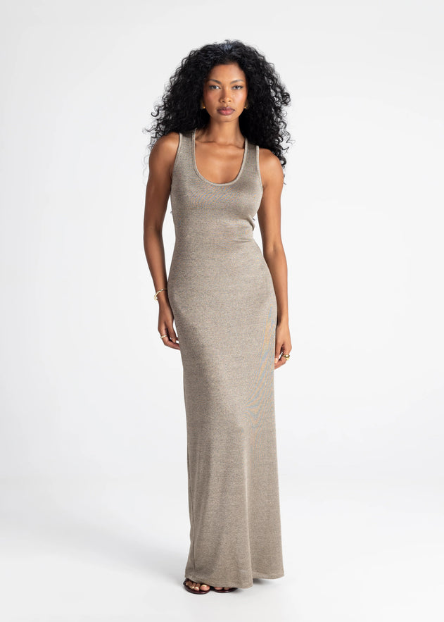 Woman wearing a long beige dress on a white background