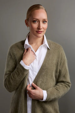 Woman wearing Original Story light olive green belted cashmere cardigan