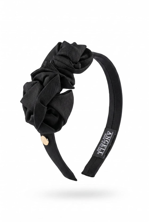 Black headband with floral design on a white background