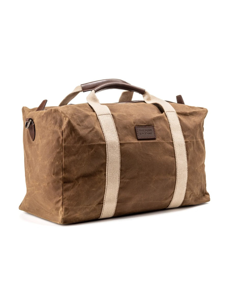 Brown waxed canvas duffel bag with white straps on a white background