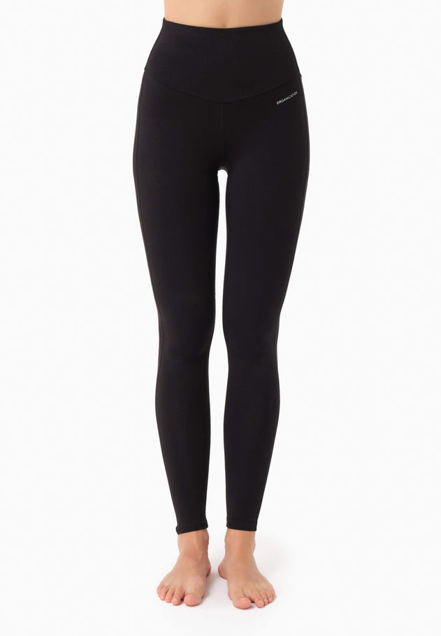 Black leggings worn by a person on a white background