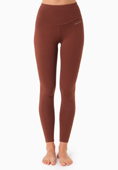 Brown leggings worn by a person on a white background