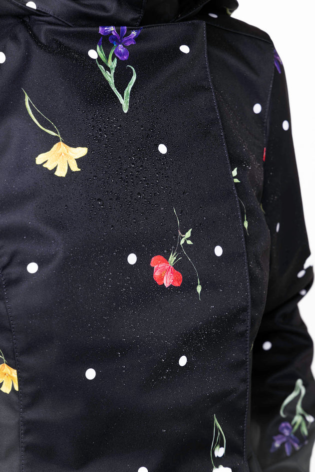 rainsisters-coat-cosmic-meadow-waterproof-black-floral-print-close-up.jpg?v=1779051267