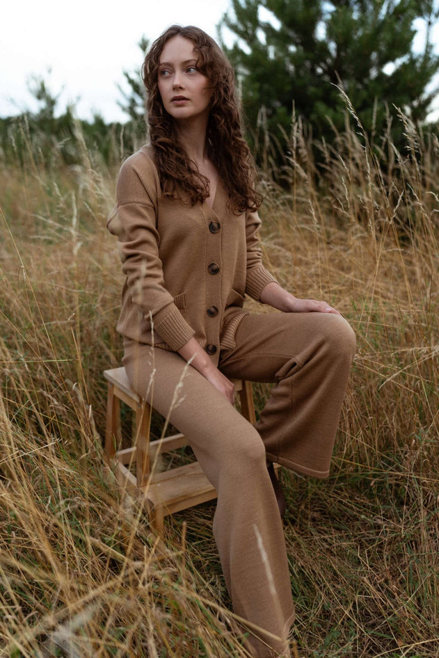 Model wearing camel merino wide-leg pants with cardigan