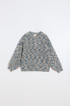 A long-sleeve knit sweater with a textured, heathered pattern in shades of blue, beige, and gray, laid flat against a clean white background.